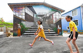 Wall-Paintings Make Village Become Tourist Resort in China'